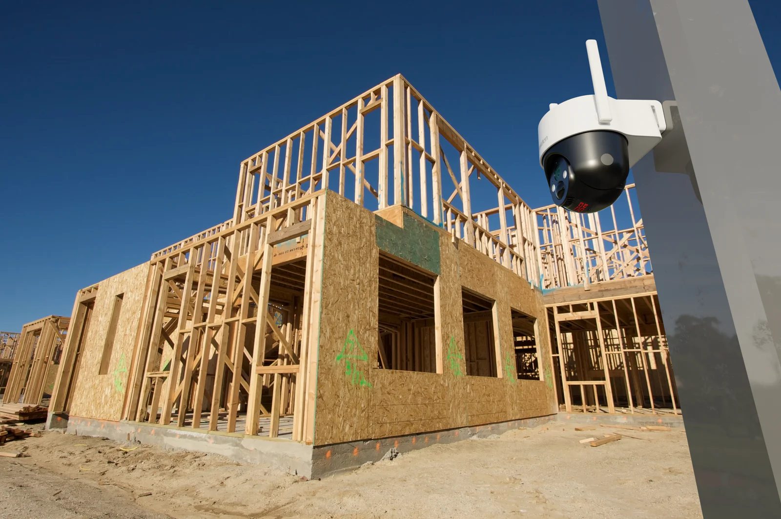 A SOLO X2K pan and tilt camera watching a house frame on a building site